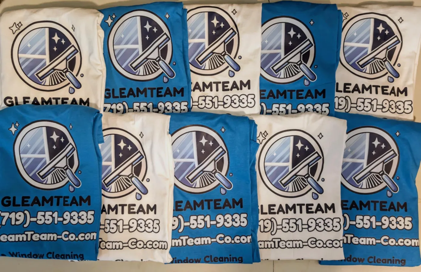 Bulk order of DTF-printed construction company shirts in multiple colors