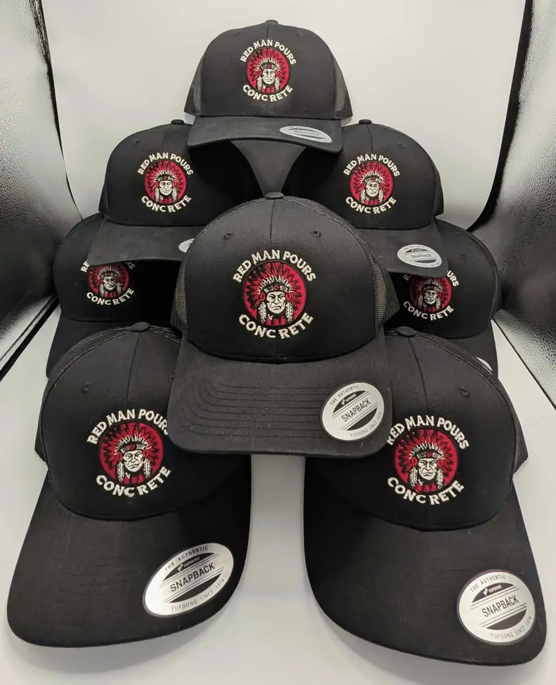 Bulk order of embroidered trucker caps with a custom company logo